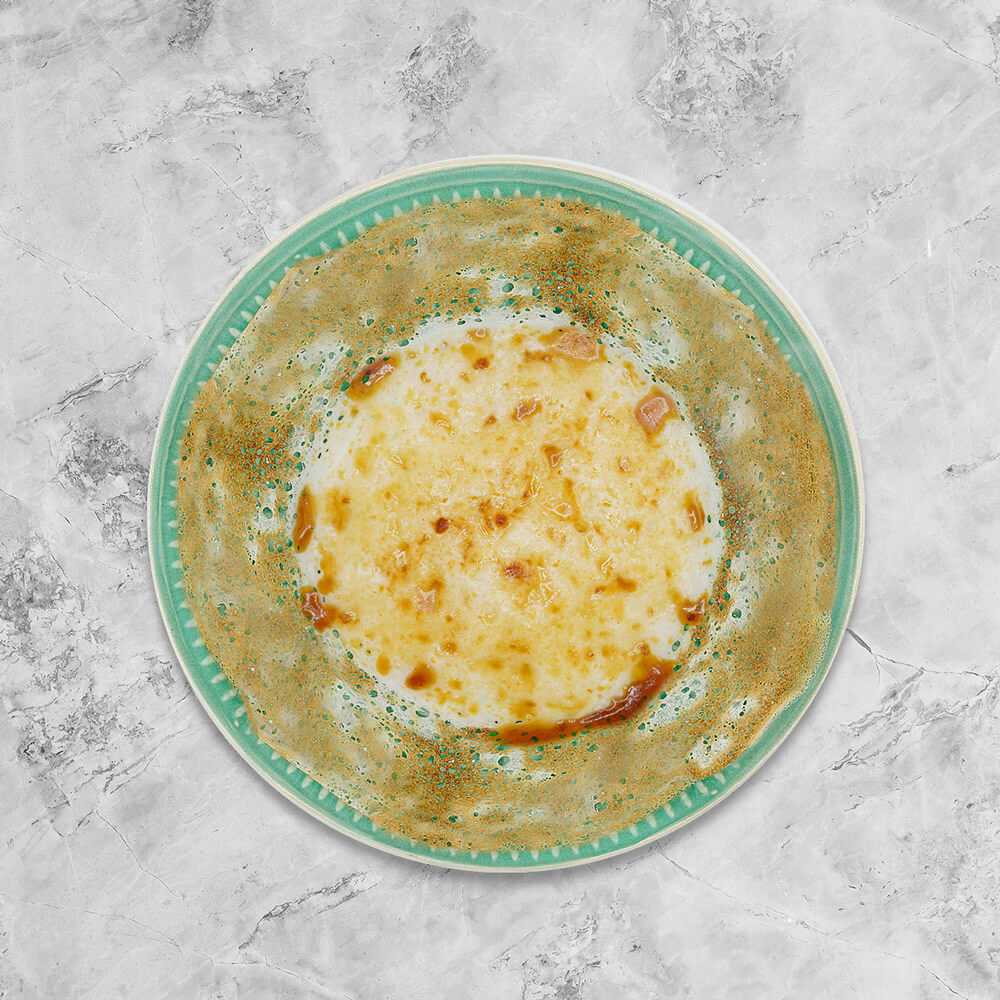 Soft in the centre and crispy on the edges, bowl-shaped fermented rice pancake served with fresh coconut milk and topped with brown sugar, freshly handmade by Amma Lalli. 