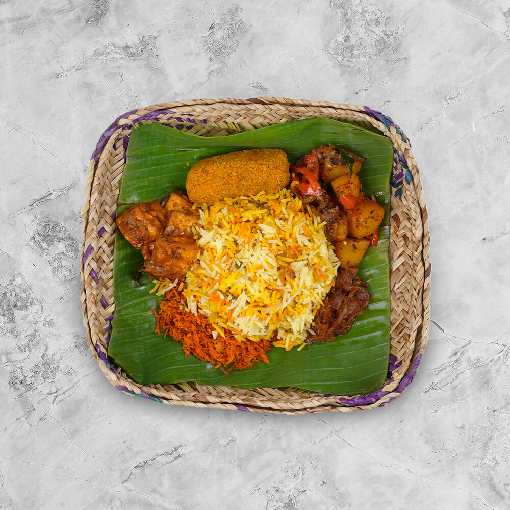 Banana leaf wrapped meal with vegetables completed with a dash of sinni sambol.